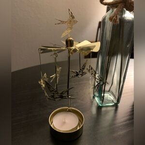 Rotating gold candle holder